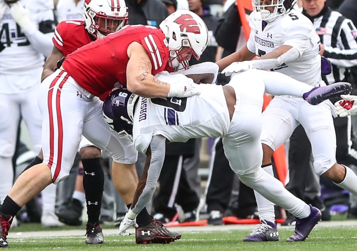 Wisconsin Badgers football's Leo Chenal (5) tackles Northwestern s Malik Washington (6) during their game Saturday, November 13, 2021 at Camp Randall Stadium in Madison, Wis. Wisconsin won the game 35-7. Doug Raflik/USA TODAY NETWORK-Wisconsin Fon Badgers Vs Northwestern Football 111321 Dcr171 LEDE 1